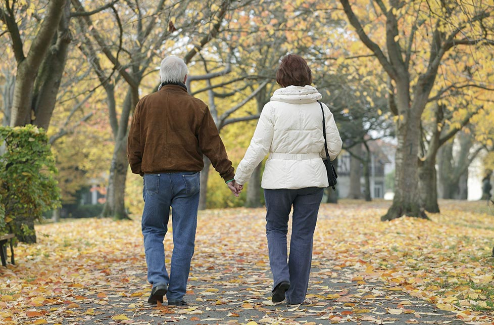 Elderly couple walking in park